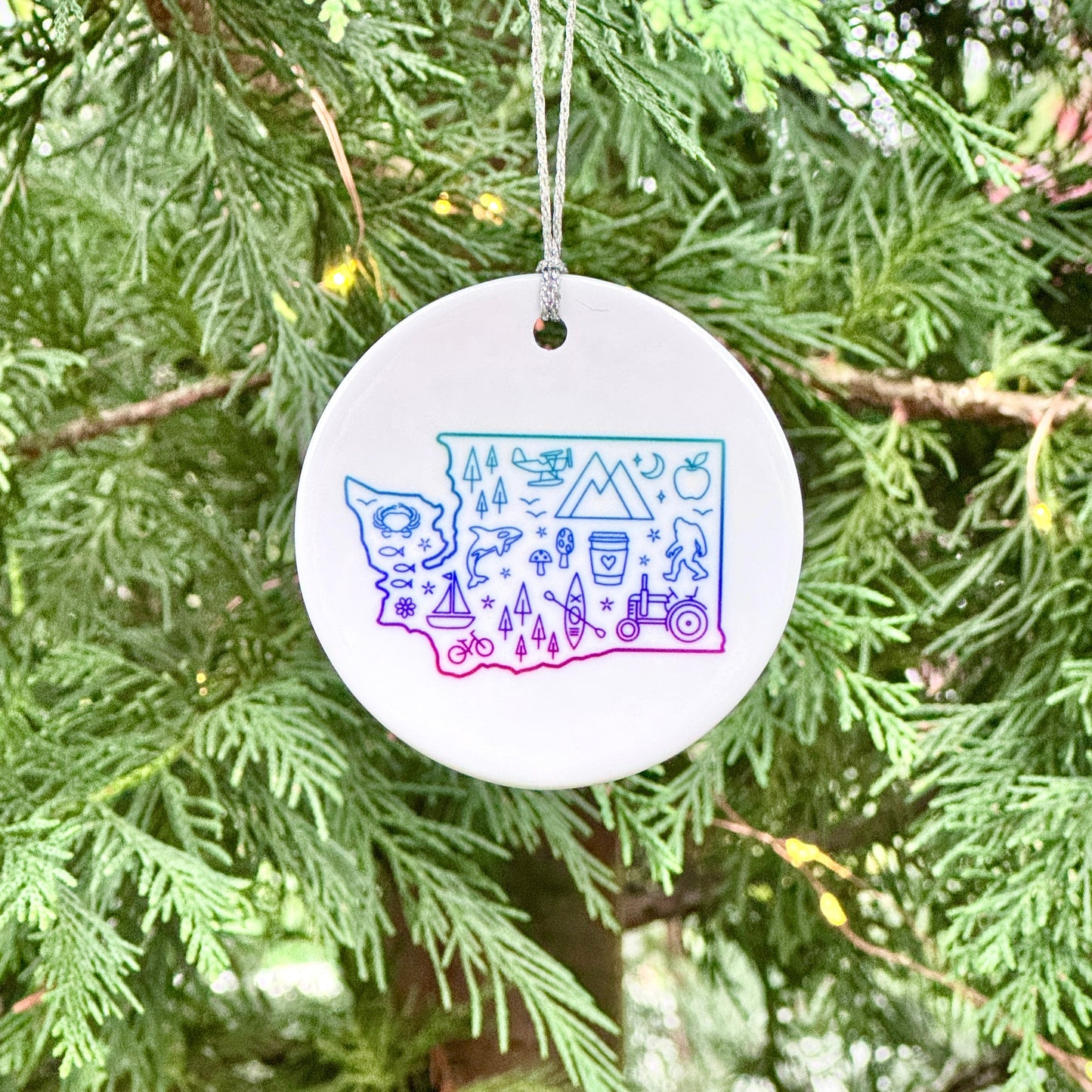 Round ornament with colorful design hanging on a tree