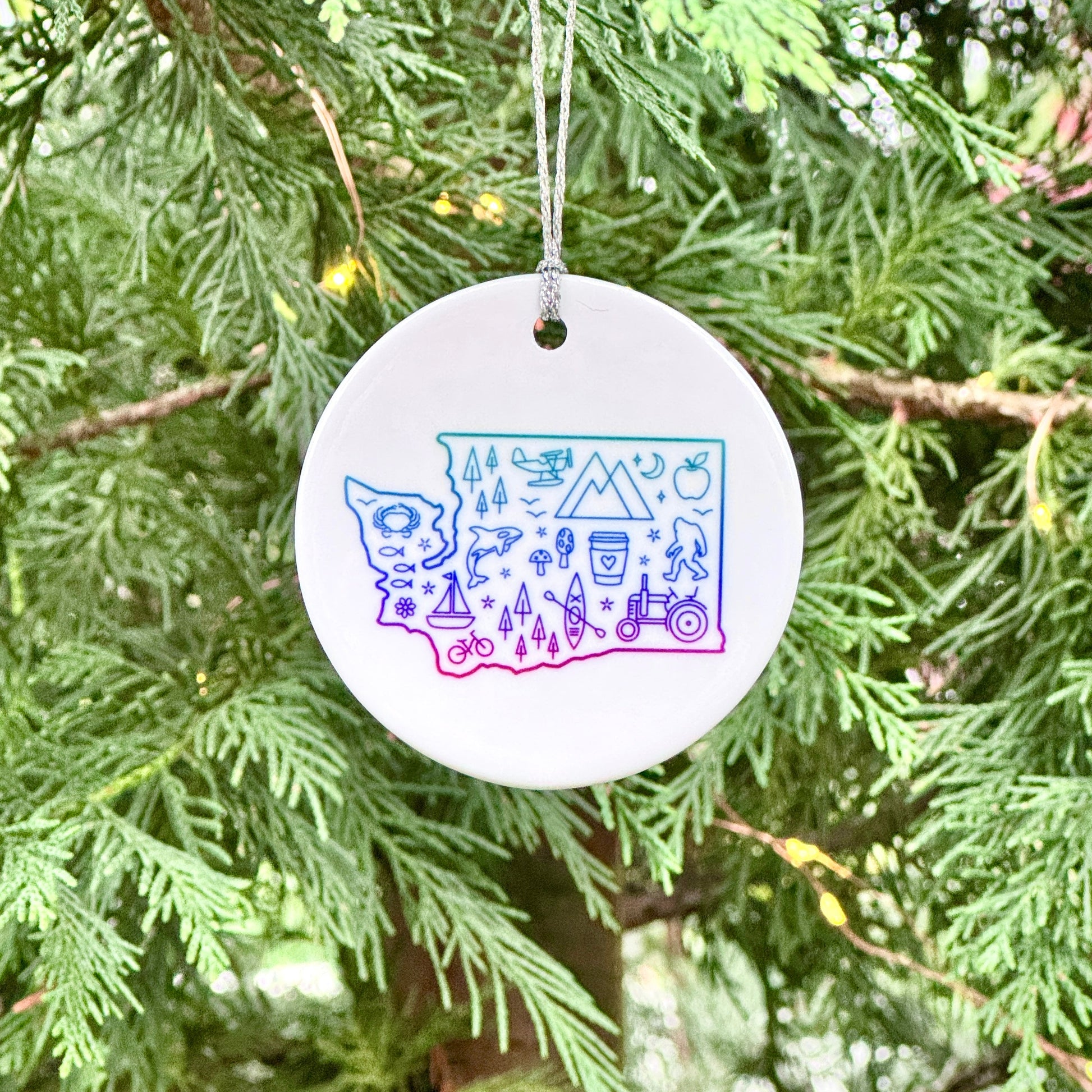 Round ornament with colorful design hanging on a tree