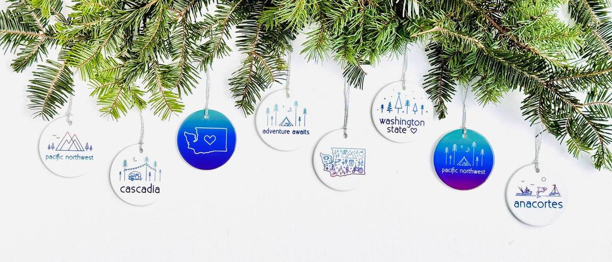 Pacific Northwest and Washington state themed Christmas ornaments hanging from a branch